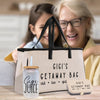 a woman and a child are sitting at a table with a bag