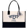 a white and black bag with a bow on it