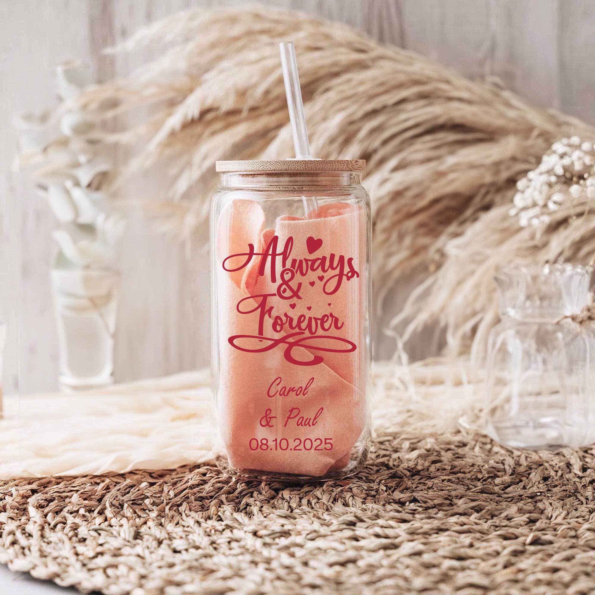 A glass jar with a straw, featuring a red and white design, sits on a woven mat.