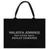 A black paper bag with white text printed on it.