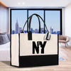 a black and white bag sitting on top of a wooden table