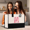 two girls sitting on a couch looking at a bag