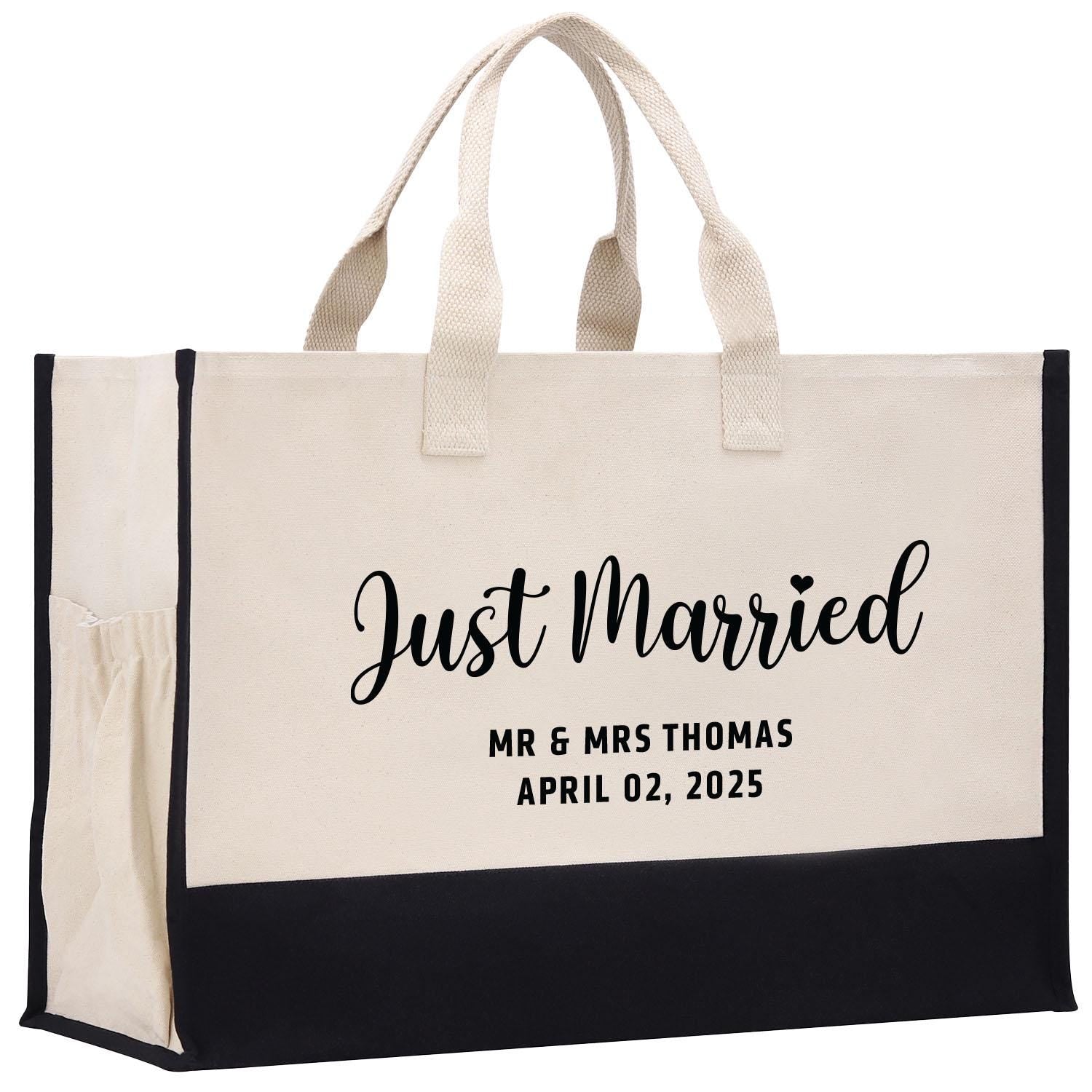 a black and white tote bag with the words just married printed on it