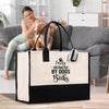 a woman sitting on a couch with a dog and a bag