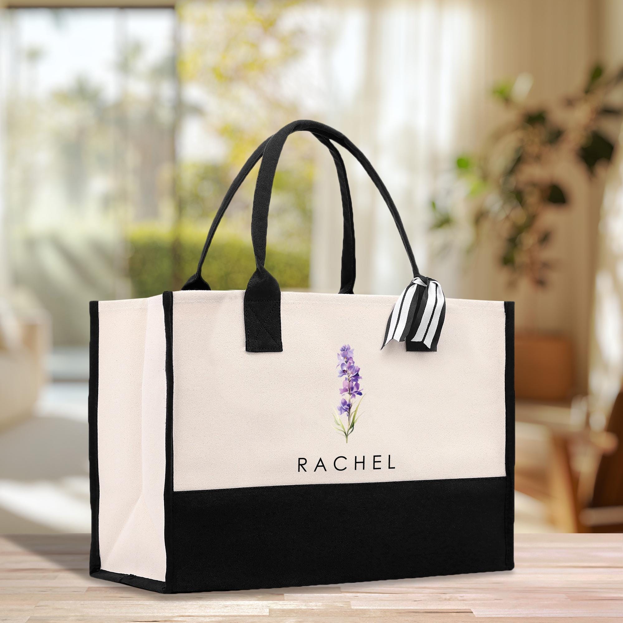 a black and white bag with a flower on it