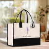 a black and white bag with a flower on it