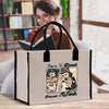 a woman reading a book while holding a bag