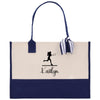 A tote bag with a navy blue trim and a white background. The bag has a tennis player silhouette and the name "Kaitlyn" printed on it.