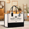 a black and white bag sitting on top of a wooden floor