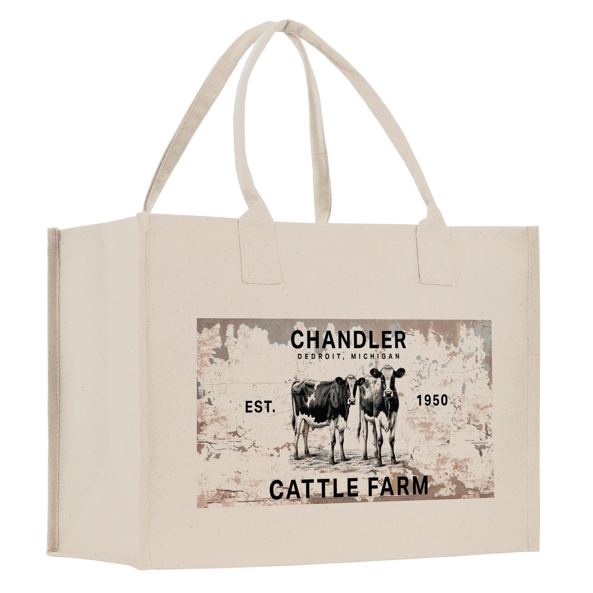 The image is a beige canvas tote bag with a printed design featuring two cows and text that reads &quot;CHANDLER Cattle Farm Est. 1950&quot;.