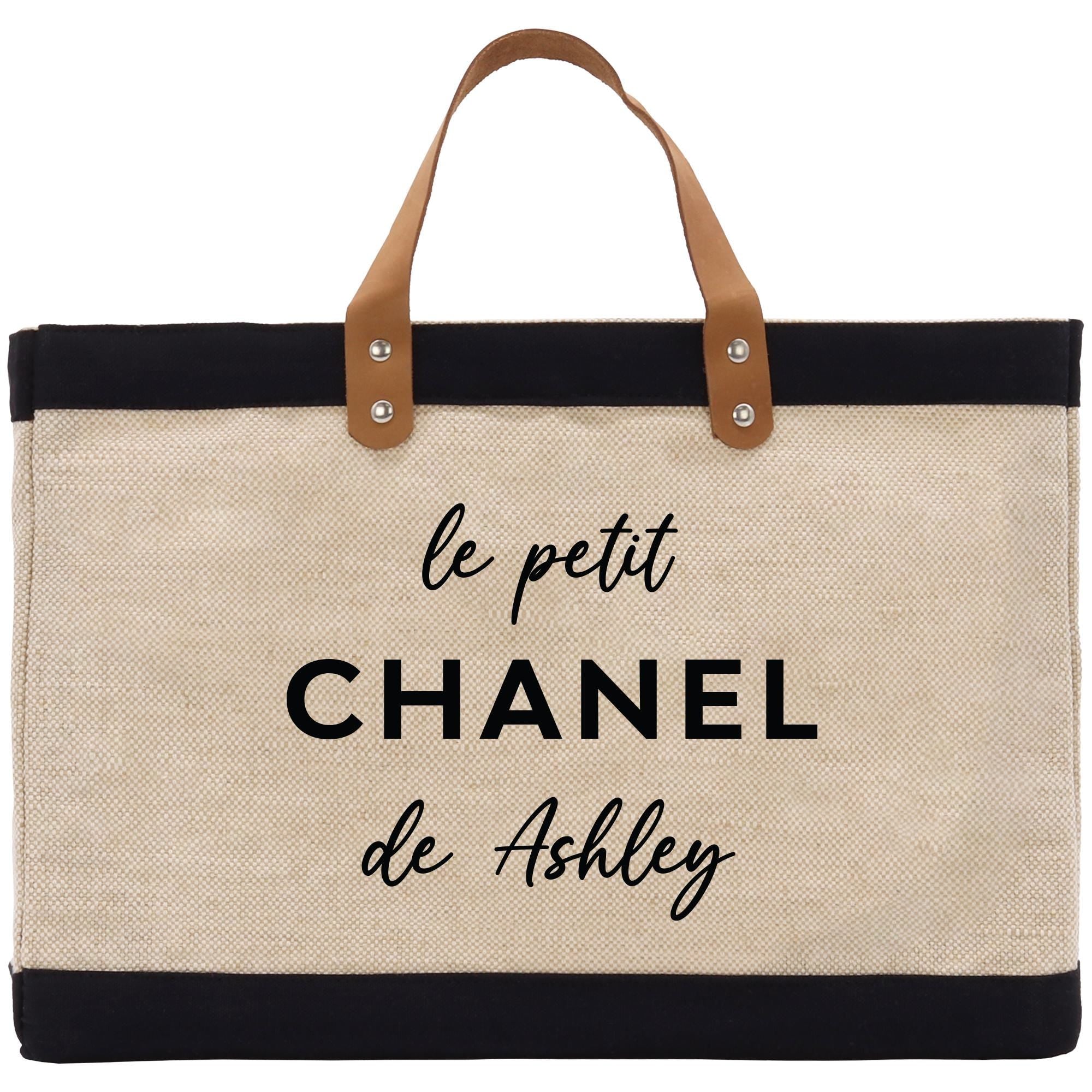a black and white tote bag with the words le petit chanel de ash