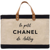 a black and white tote bag with the words le petit chanel de ash