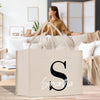 a woman sitting on a couch with a bag in front of her