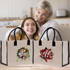 a woman and a girl sitting on a couch with two shopping bags