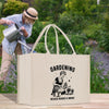 a woman is watering her garden with a watering can