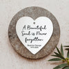 a heart shaped plaque with a quote on it