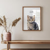 a picture of a cat is hanging on a wall