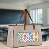 a canvas bag with the word teach painted on it