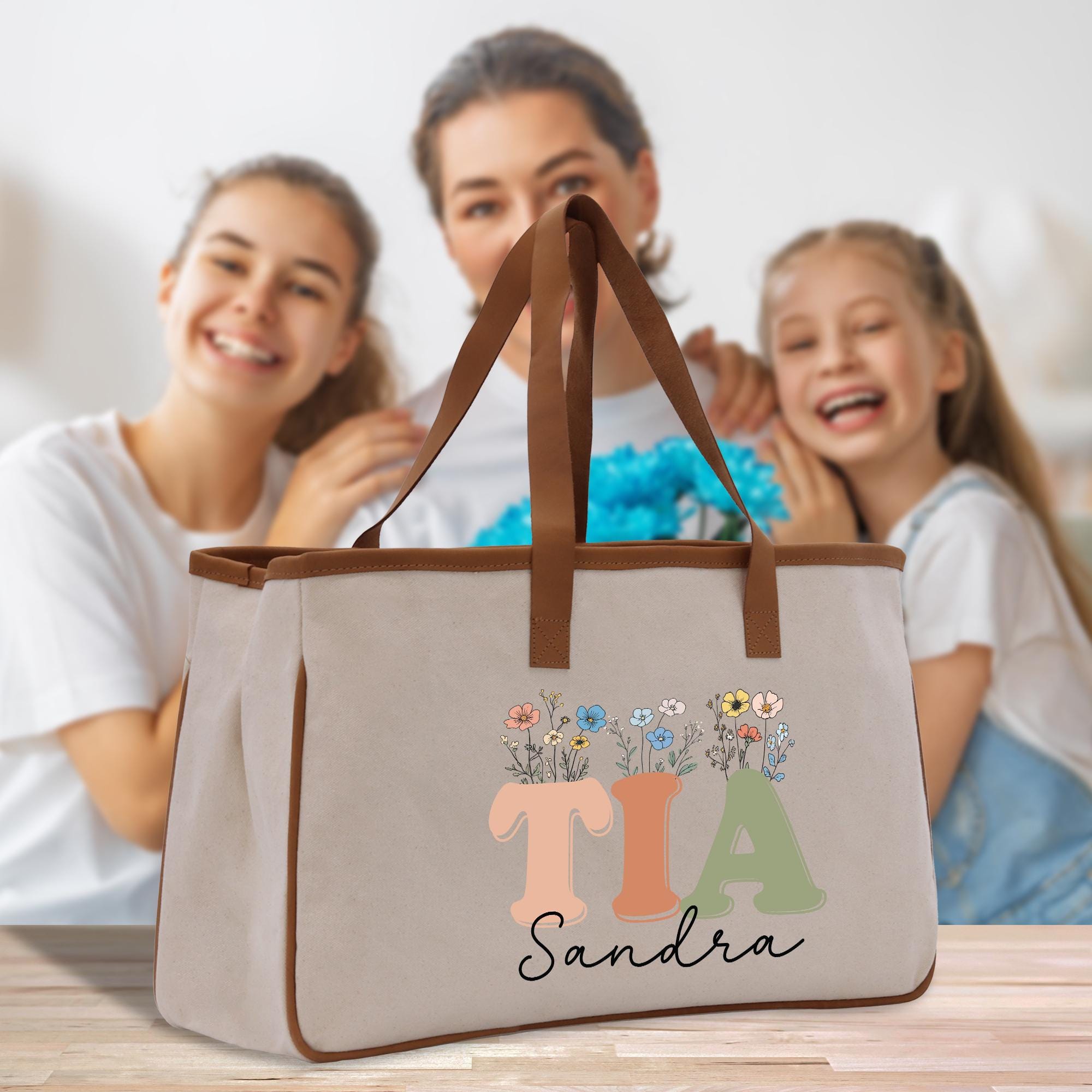 a woman and two girls are holding a tote bag