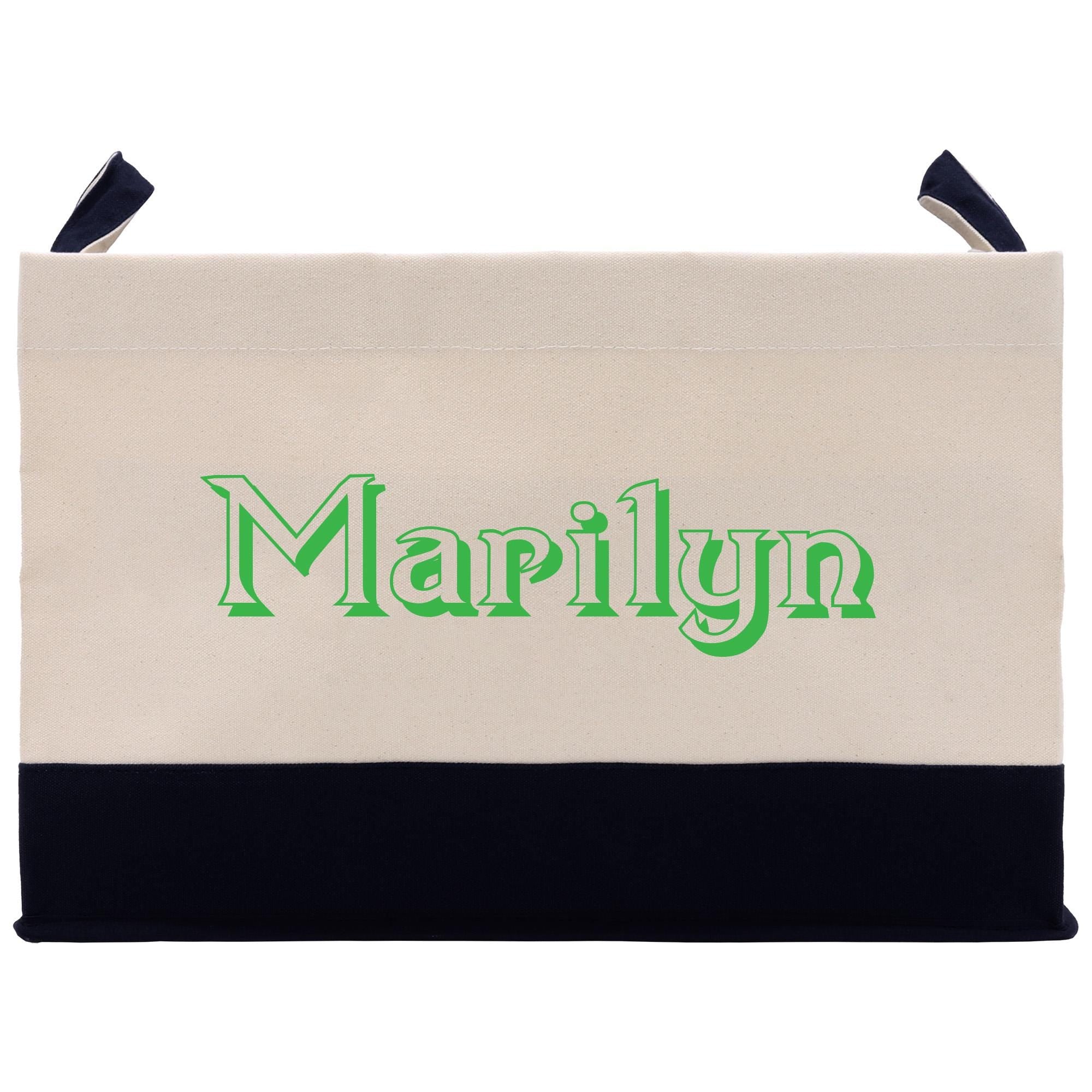 A beige tote bag with the word &quot;Marilyn&quot; printed in green on it.