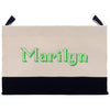 A beige tote bag with the word "Marilyn" printed in green on it.