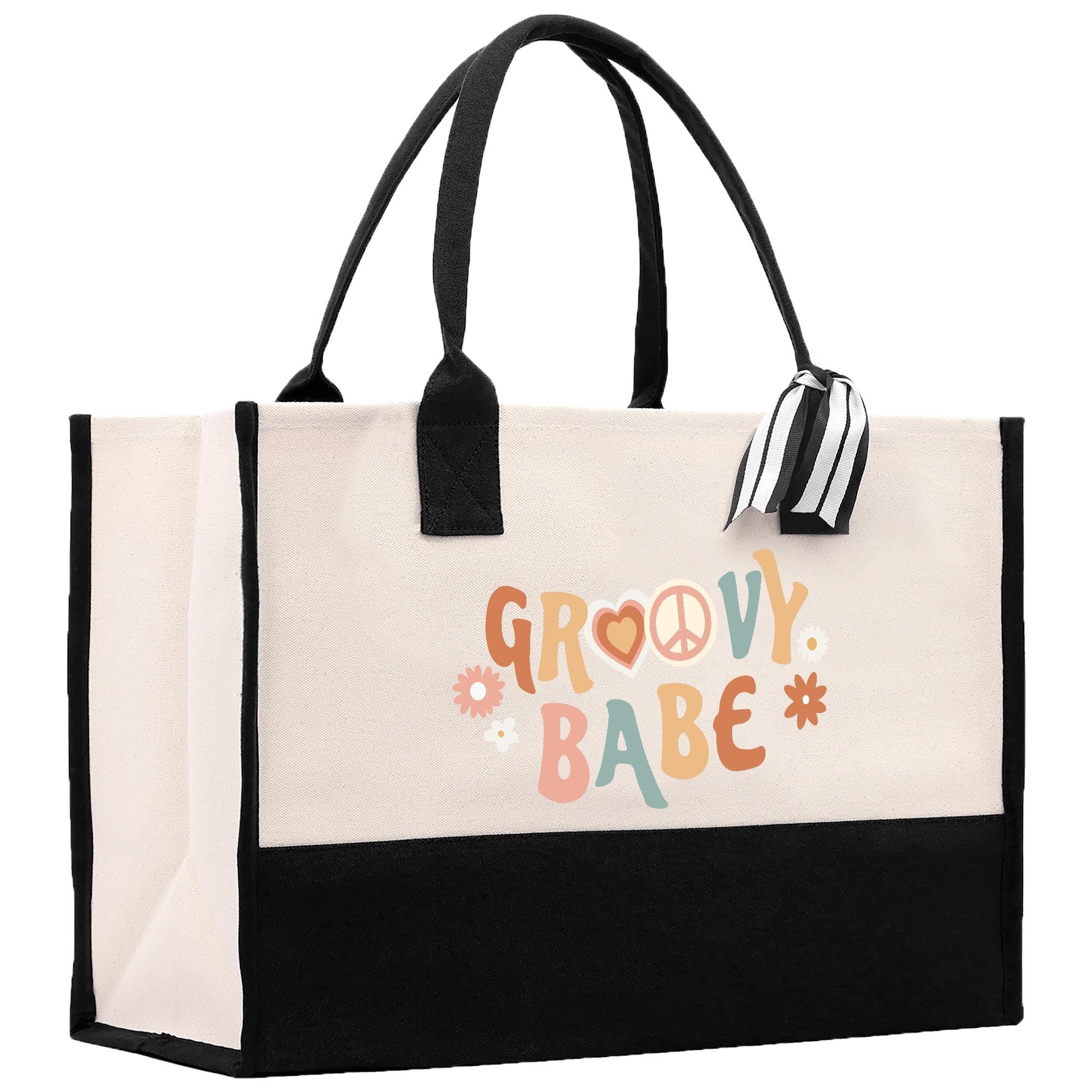 A large tote bag with a black and white striped handle and a peace sign printed on it.