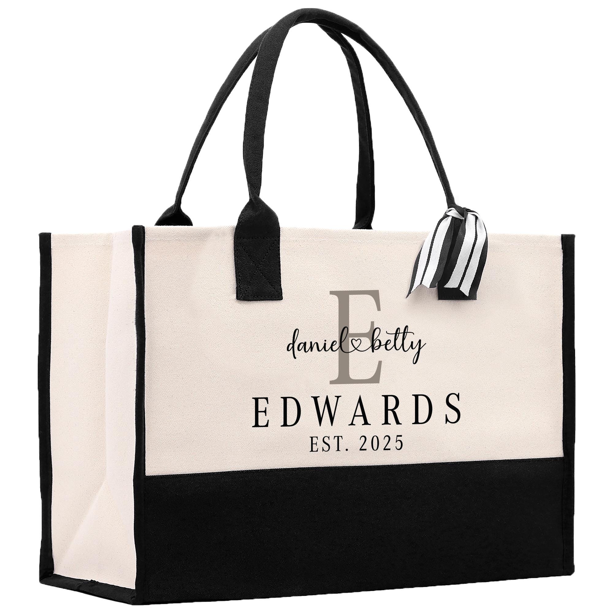 a black and white bag with a monogrammed handle