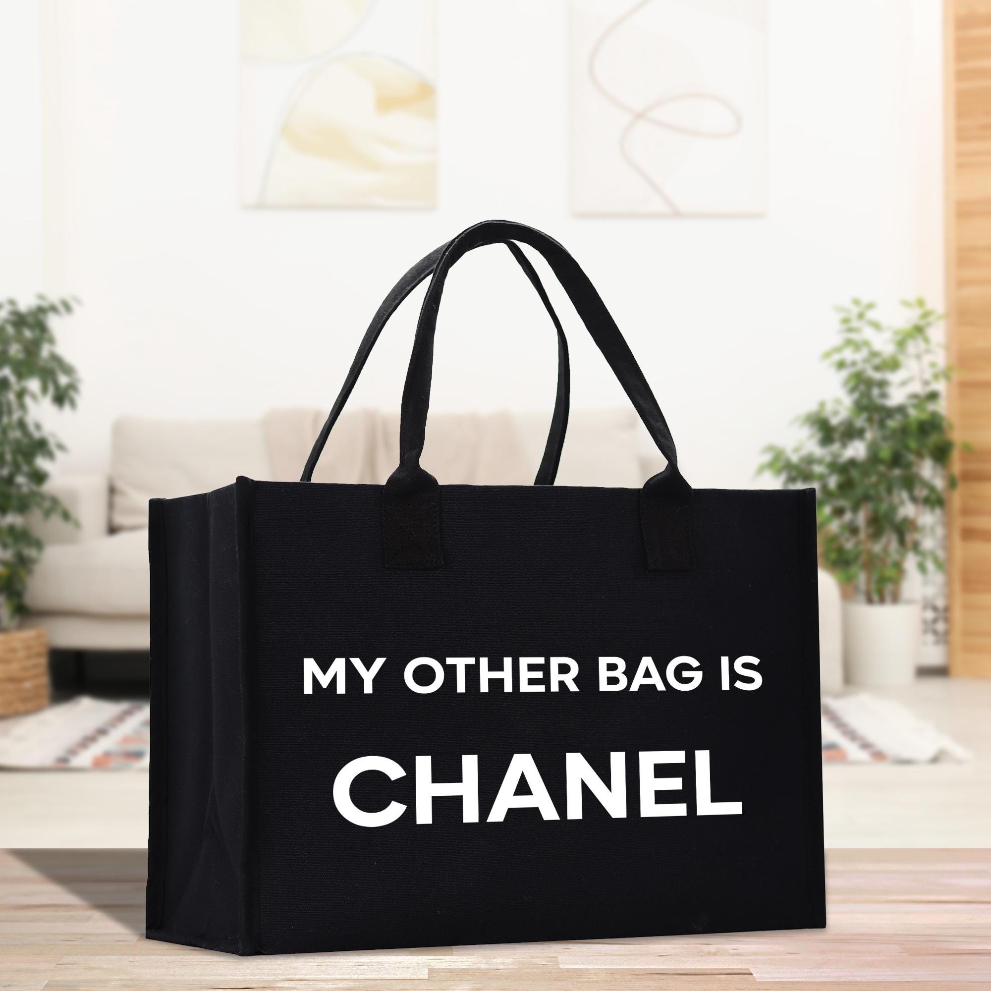 a black bag that says, my other bag is chanel