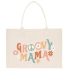 A beige tote bag with the text "GROOVY MAMA" printed on it, surrounded by colorful flower illustrations.