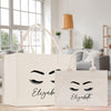 two bags with eyelashes on them sitting on a table