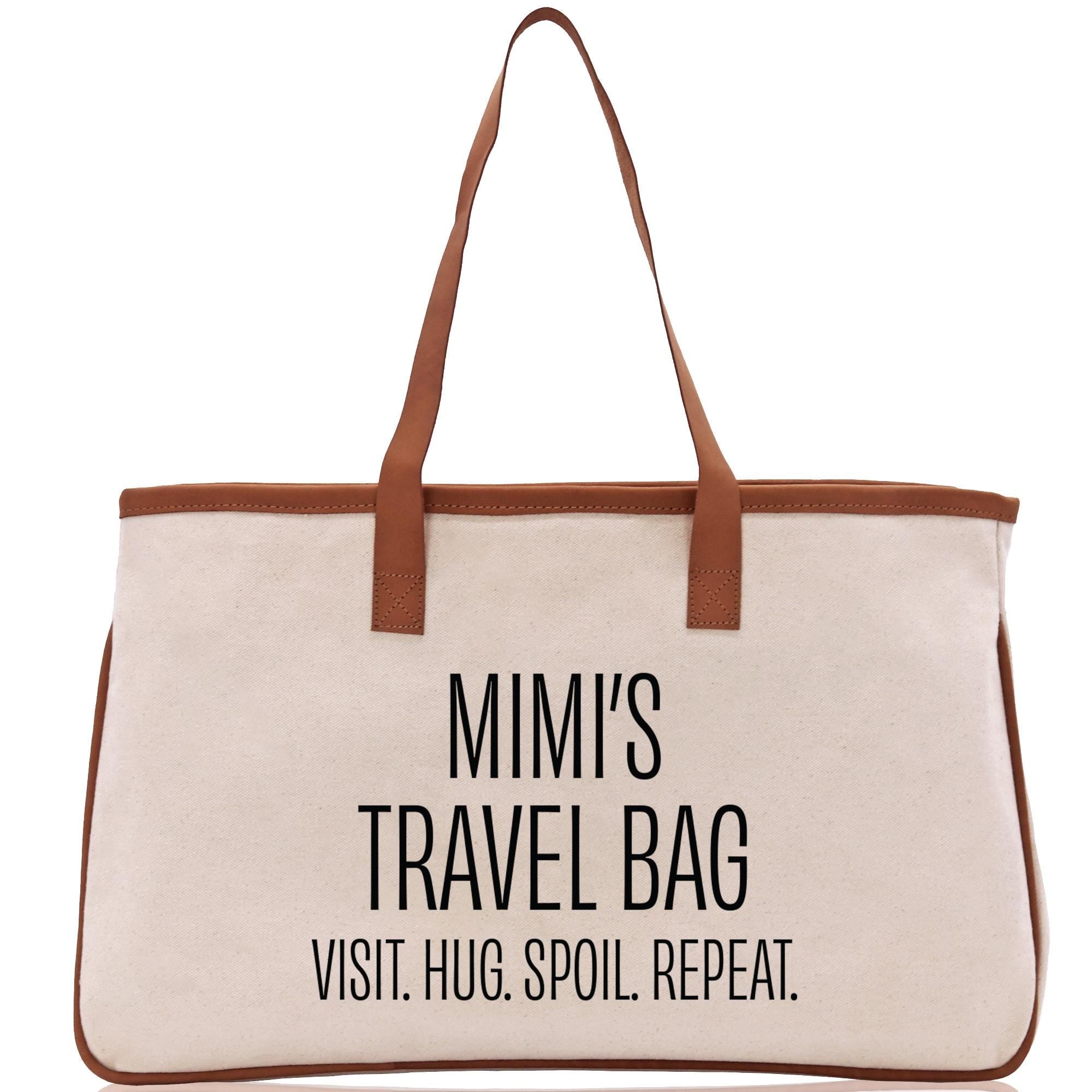 a canvas bag with a brown leather handle