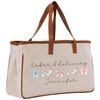 a white bag with a brown leather handle