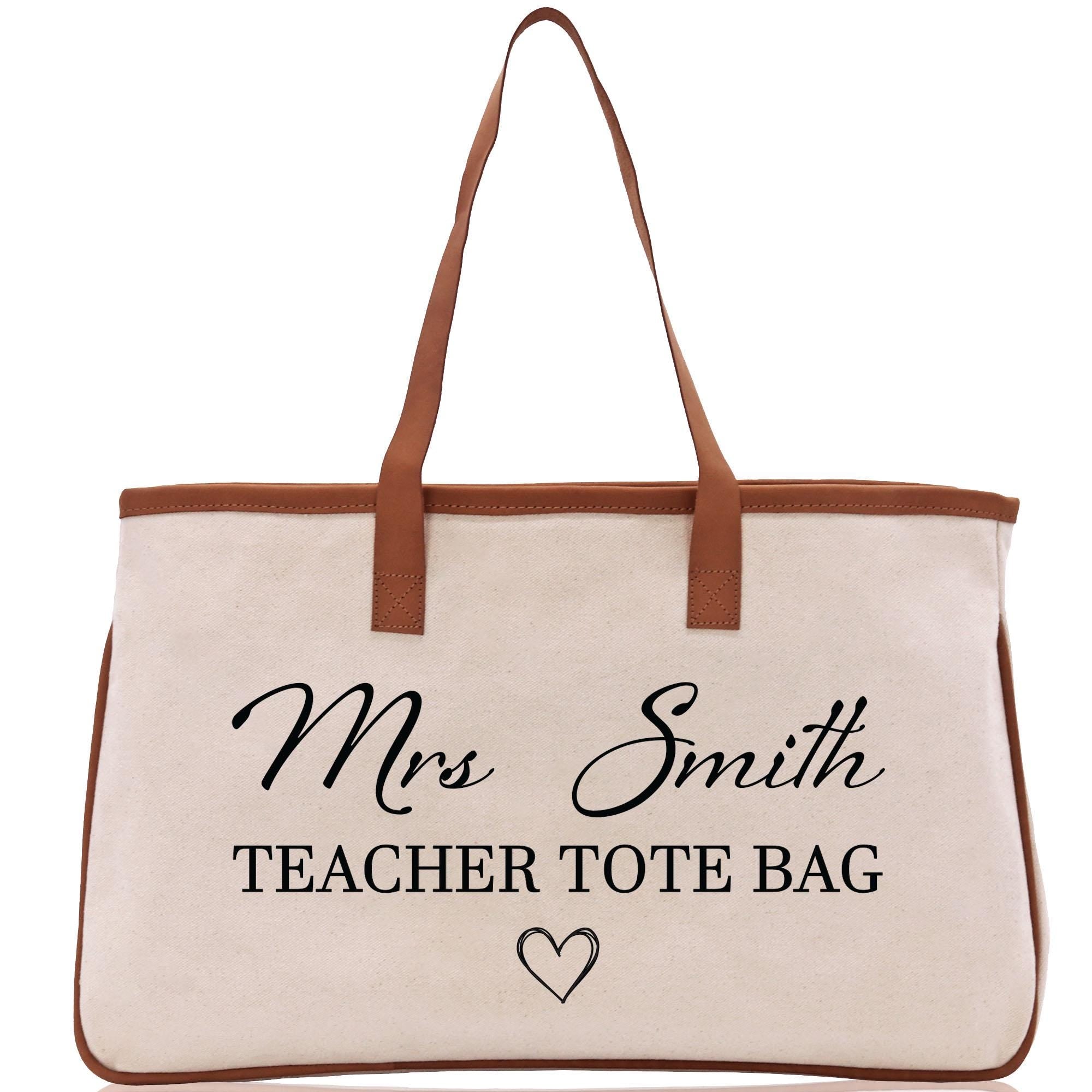 a white bag with a brown leather handle
