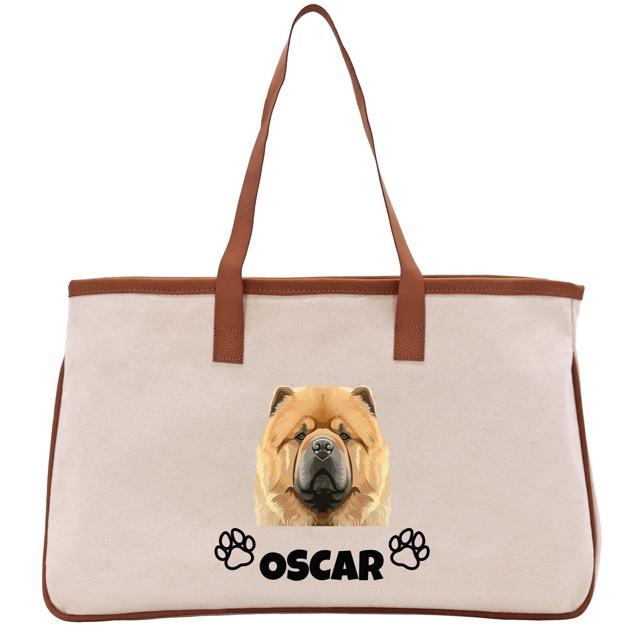 A beige tote bag with a brown handle and a printed image of a chow dog&#39;s face, along with the name &quot;OSCAR&quot; below it.