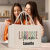 two women sitting on a couch looking at a bag