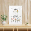 A white poster with a floral design and text, placed on a wooden surface next to a potted plant.