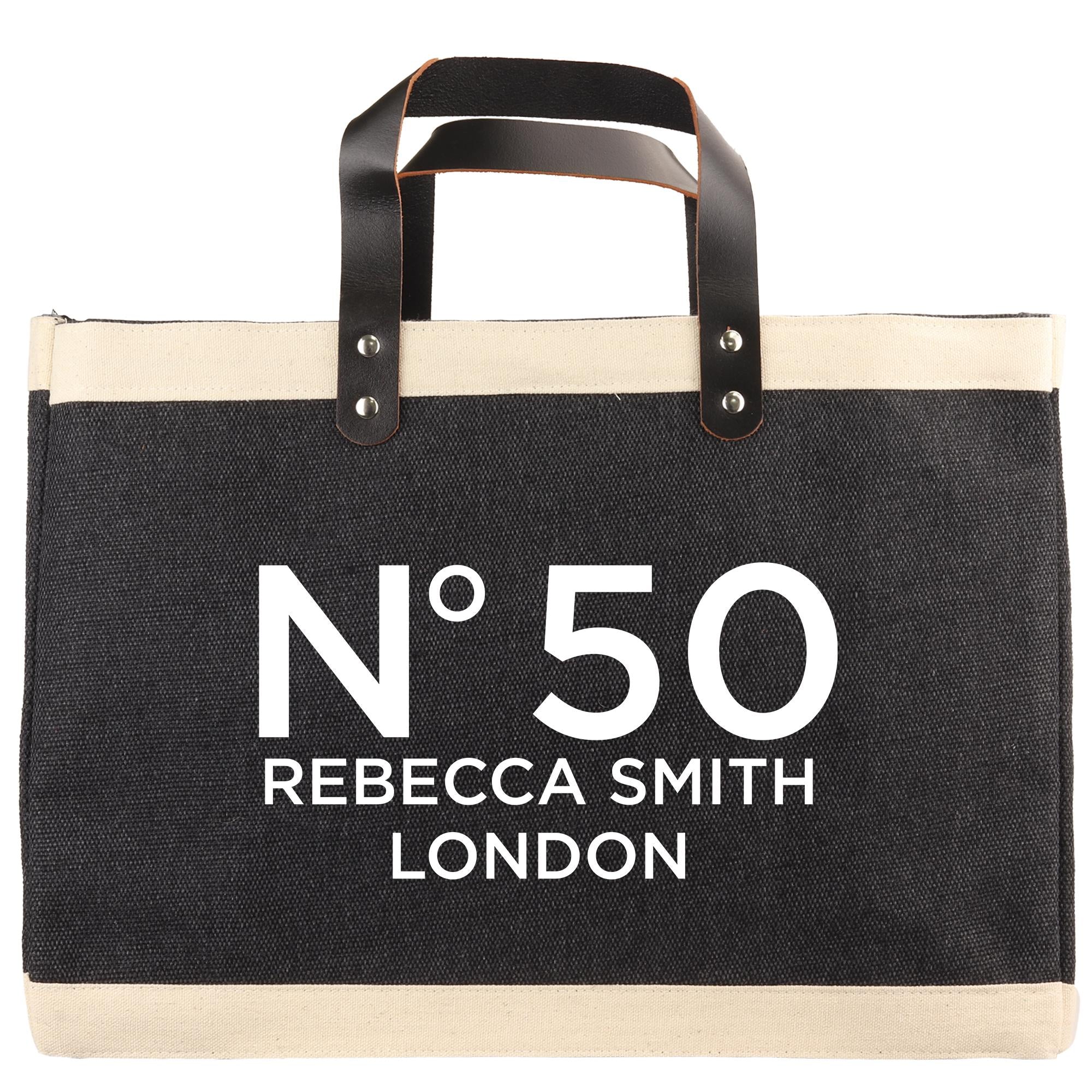 A black and beige tote bag with the text "N°50 Rebecca Smith London" printed on it.