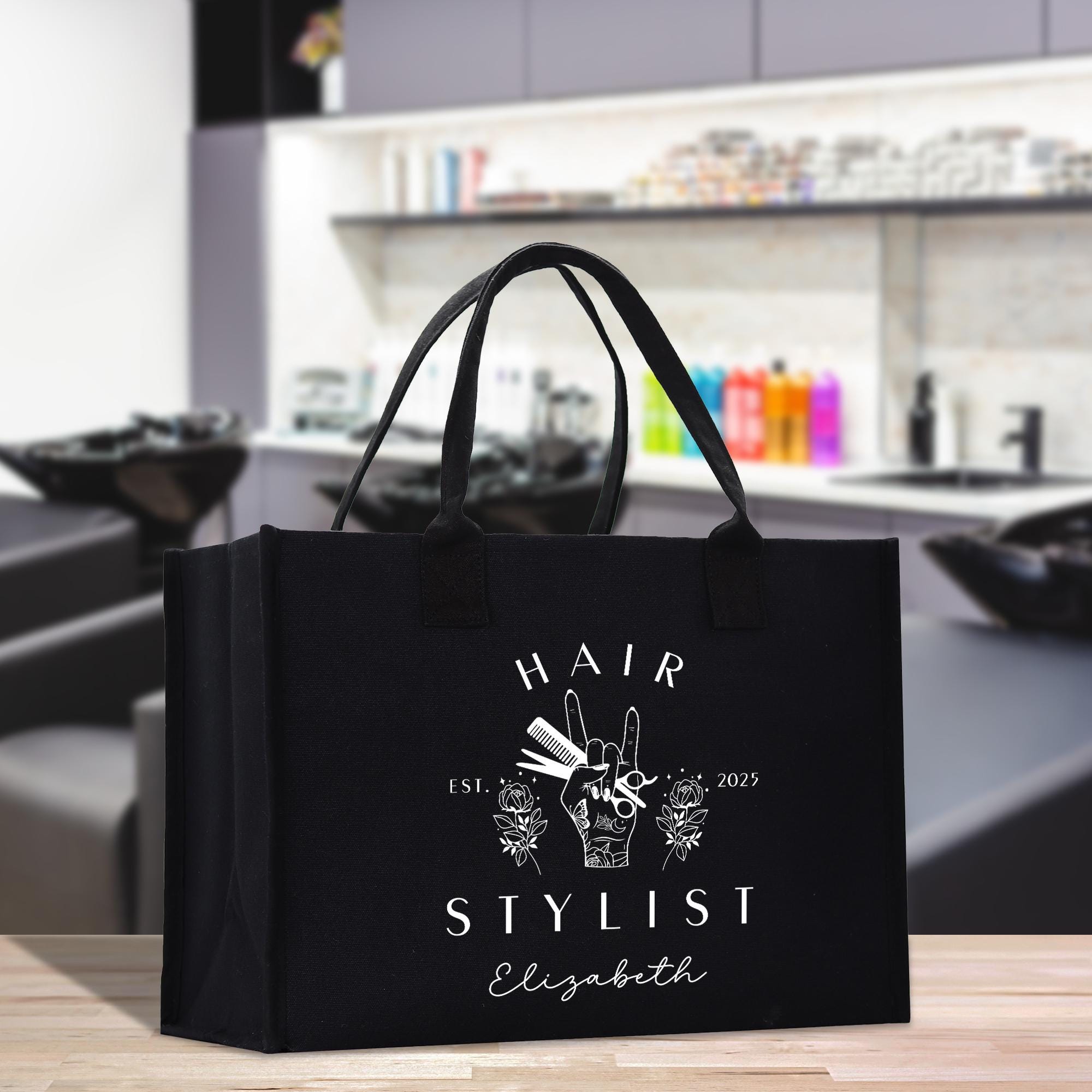 a black shopping bag sitting on top of a wooden table