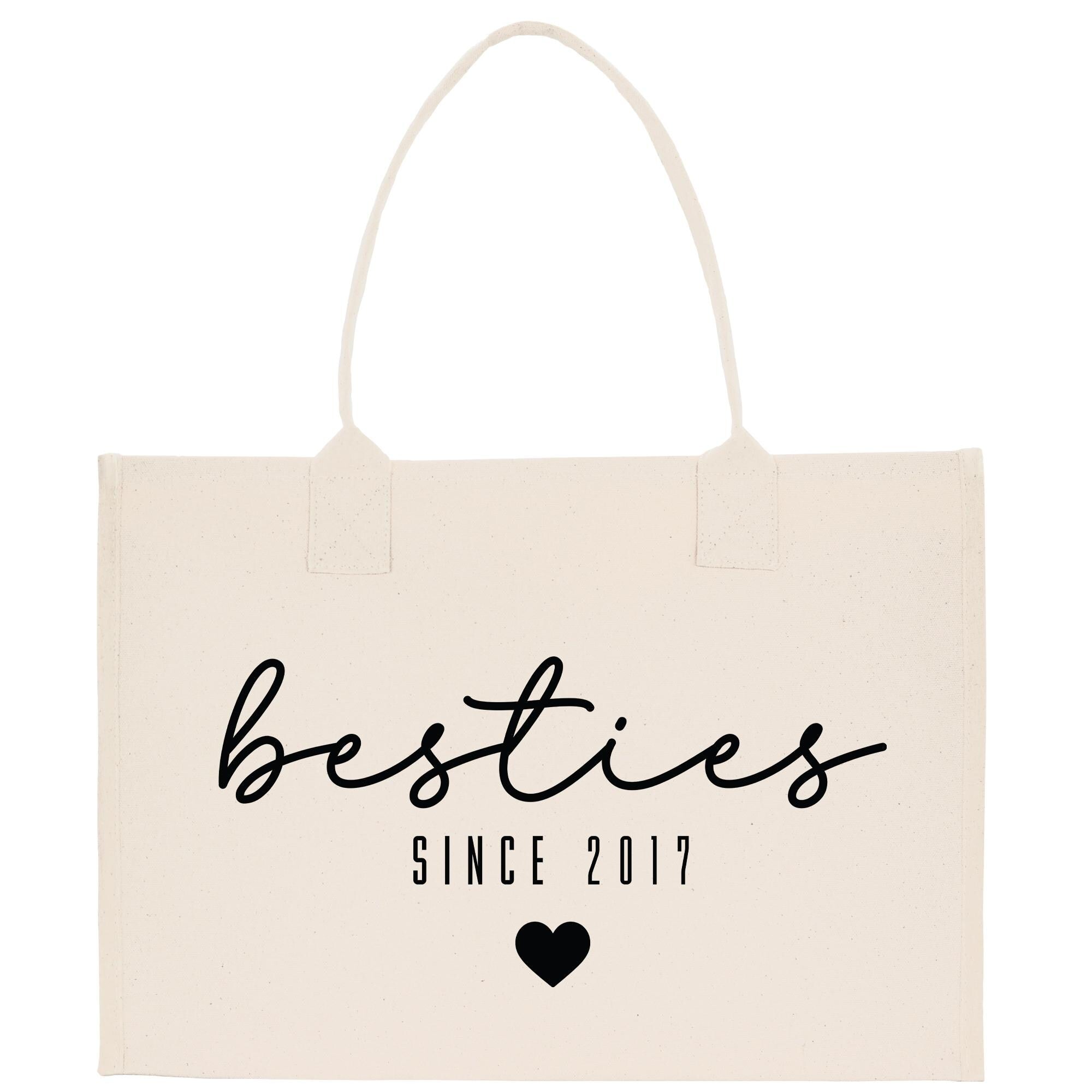 A beige canvas tote bag with the text &quot;besties SINCE 2017&quot; printed on it.