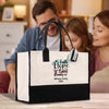 A large white tote bag with a black handle and straps, featuring a colorful design and text that says "Faith Hope Love Family" and "Williams Family 2020".
