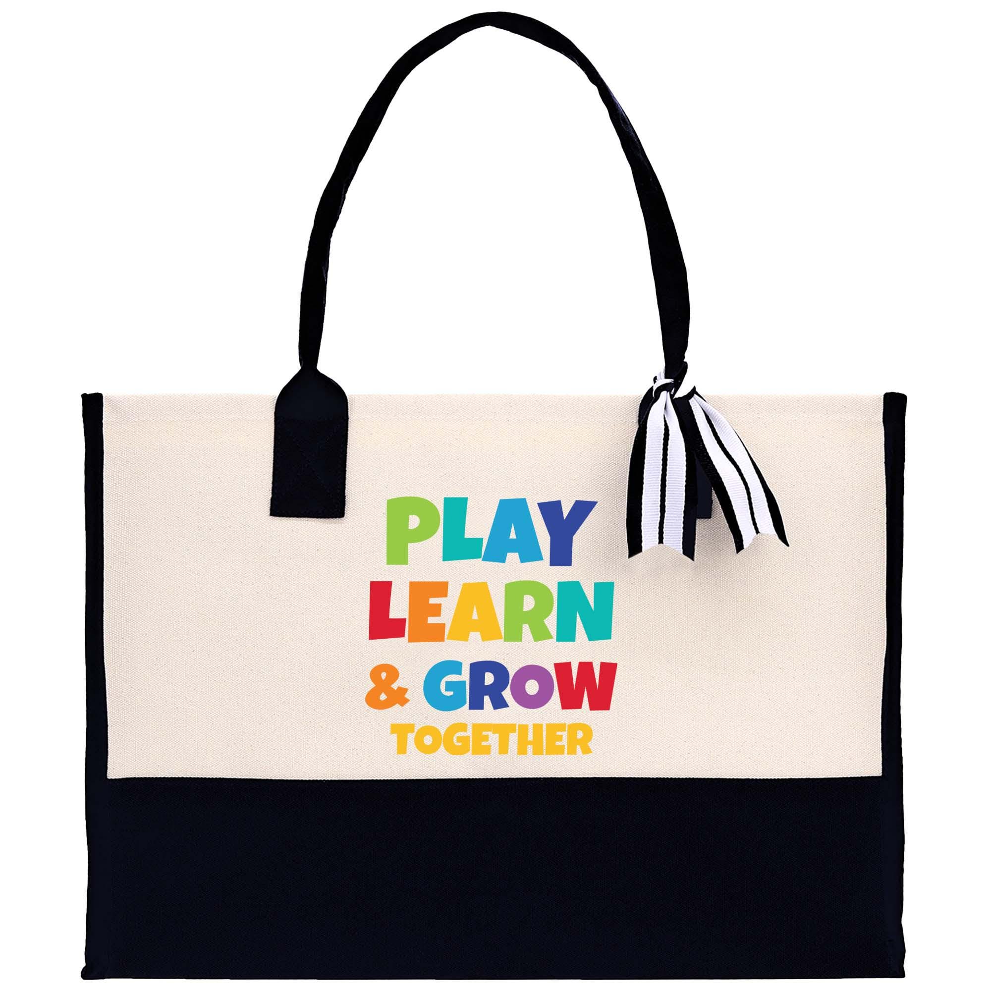 a white and black tote bag with play learn and grow together