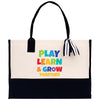 a white and black tote bag with play learn and grow together