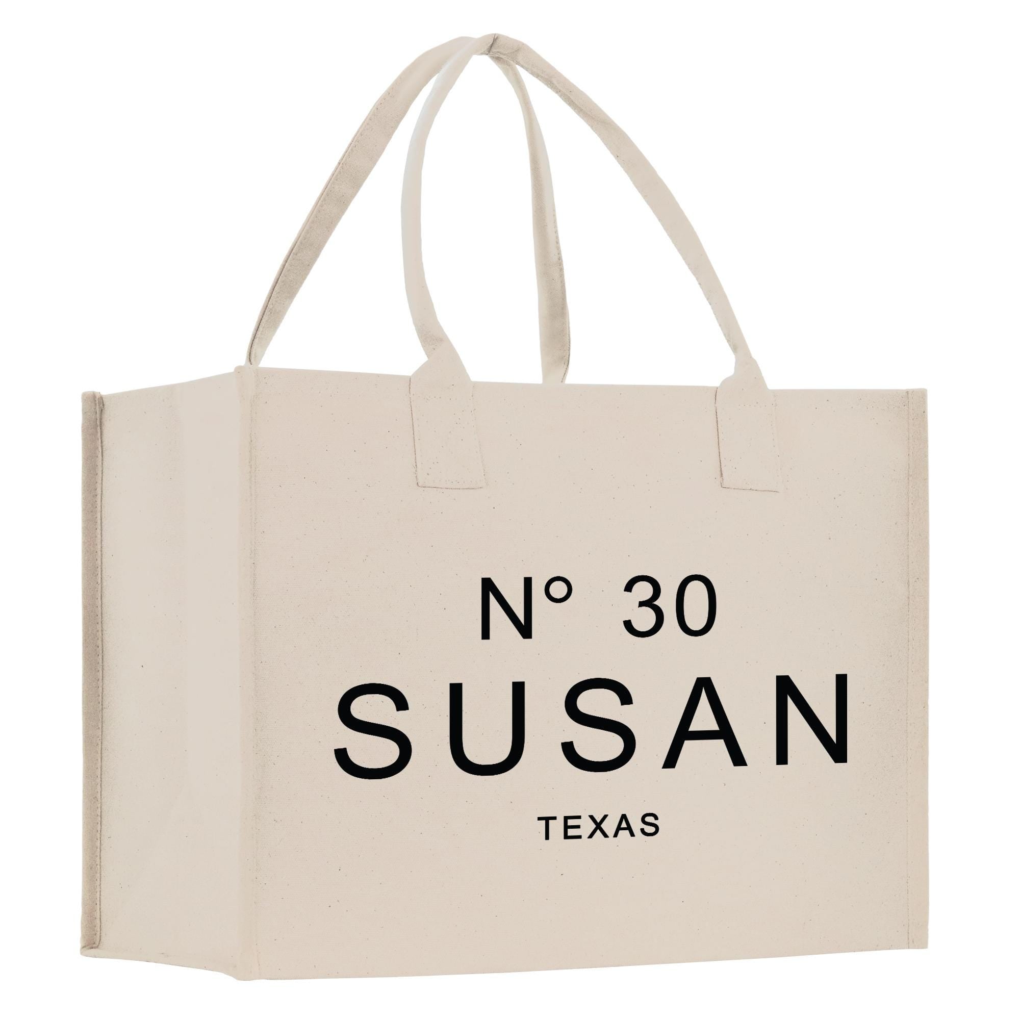 A beige canvas tote bag with the text &quot;N° 30 SUSAN TEXAS&quot; printed on it.
