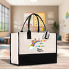 a white and black bag with a rainbow on it