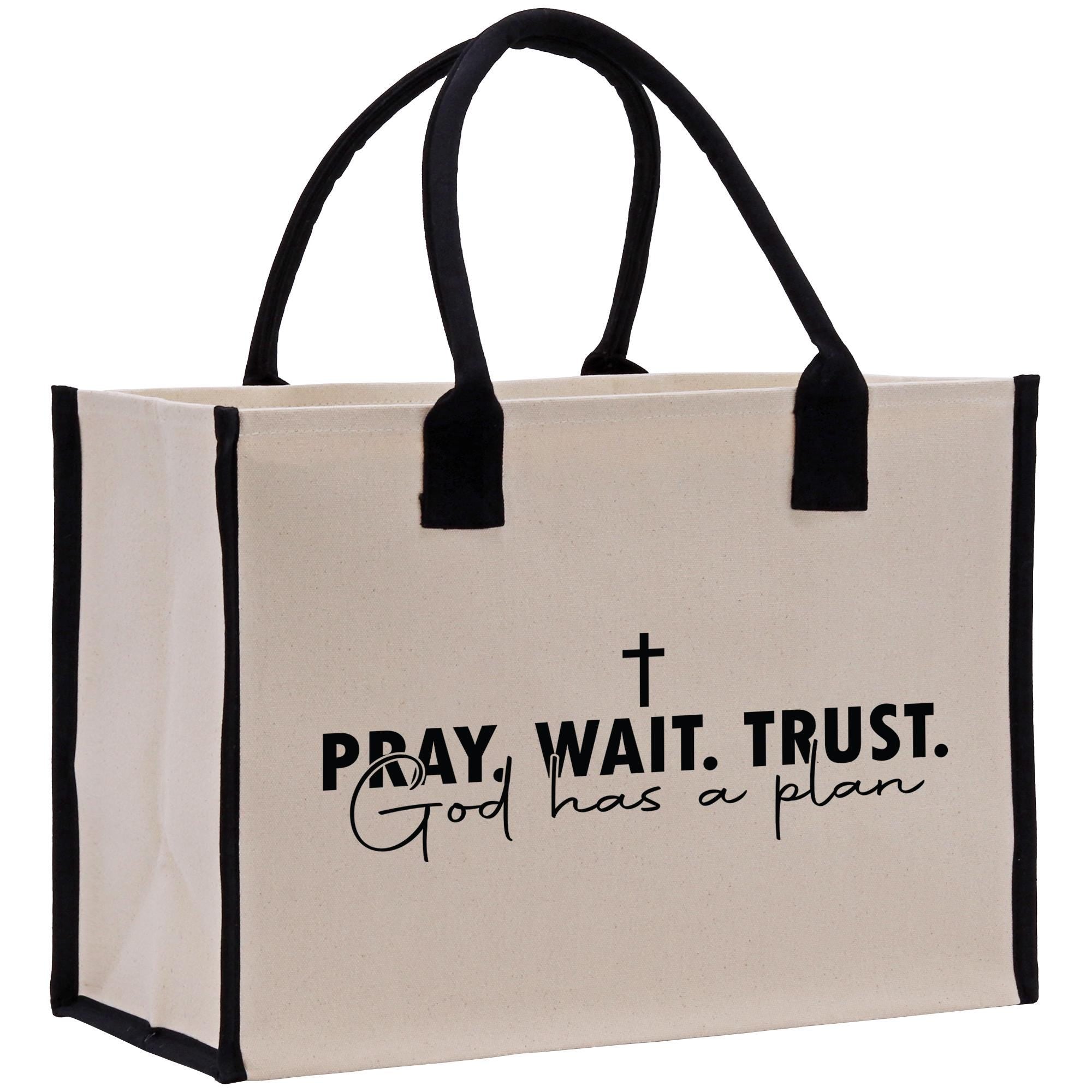 a bag with a cross on it that says pray wait trust god has a plan