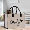a white bag with a black handle and a name on it