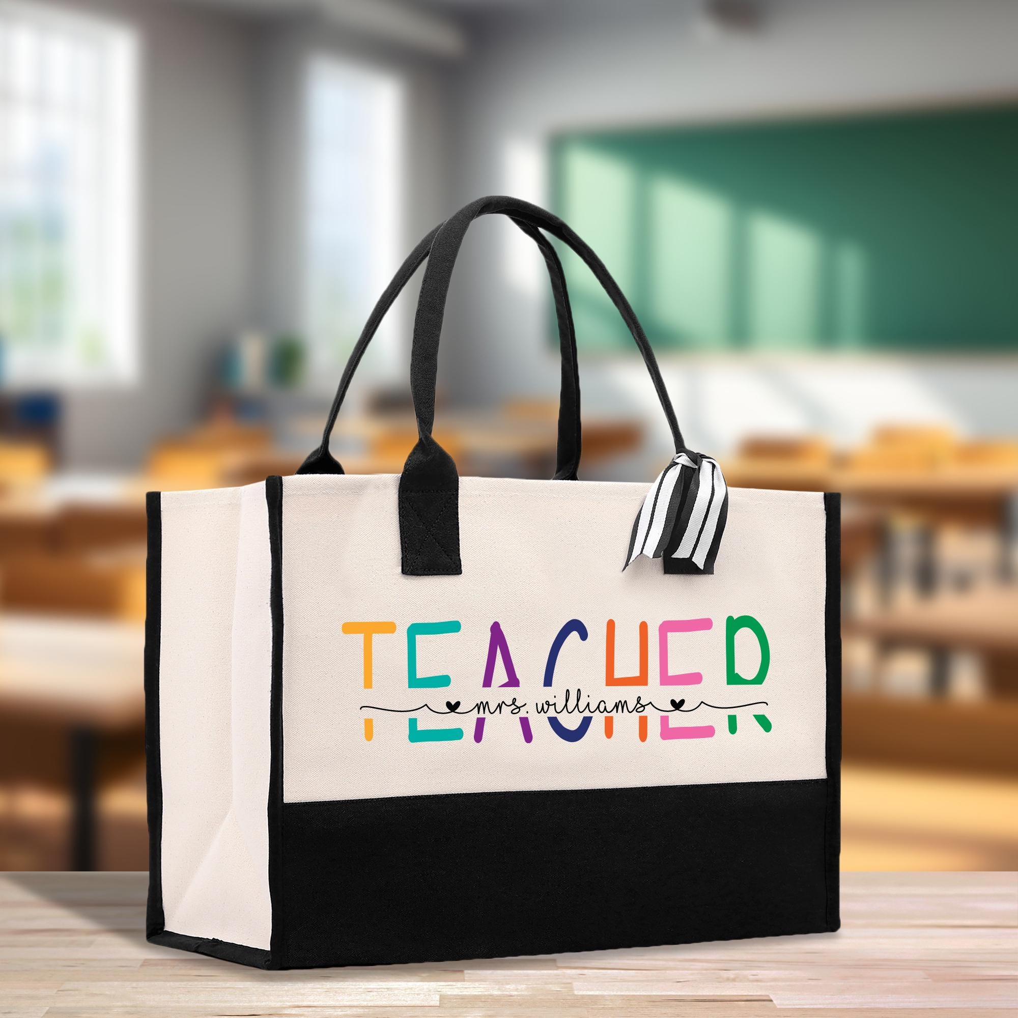a black and white bag with a teacher written on it