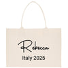 a white shopping bag with a black lettering on it