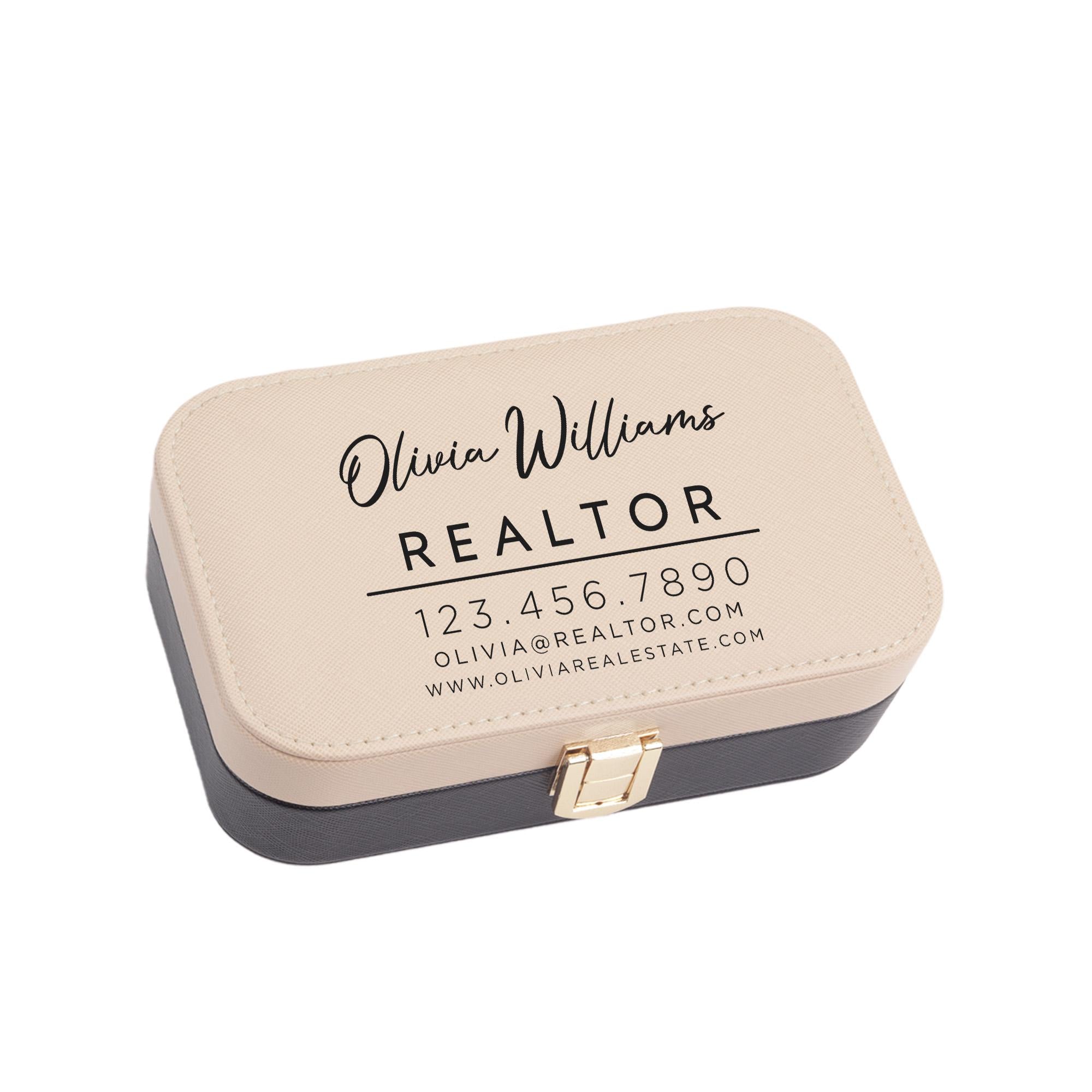 a rectangular business card holder with a tan and black color scheme. The holder has a gold clasp and displays the text &quot;Olivia Williams REALTOR&quot; and a contact number &quot;123 456-7890&quot; along with the website &quot;Olivia@REALTOR.com&quot;.