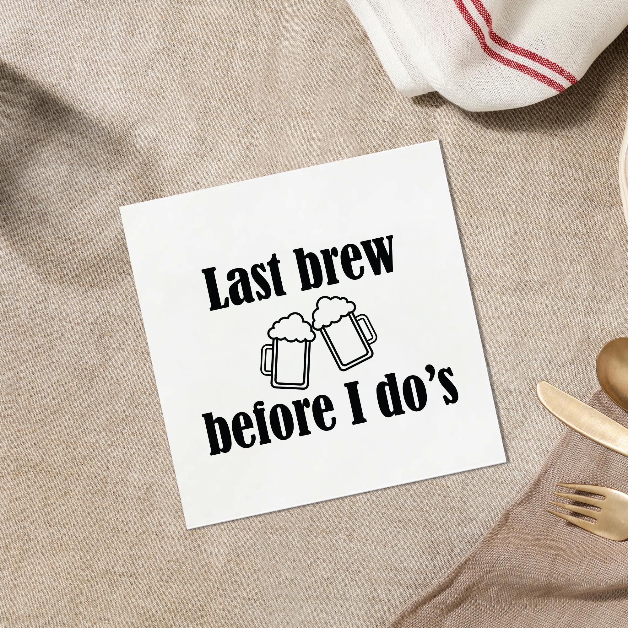 a white napkin with a humorous text printed on it, placed on a table with various tableware items such as a fork, knife, and spoon.